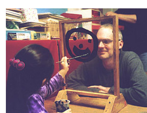 A young artist paints George's portrait.